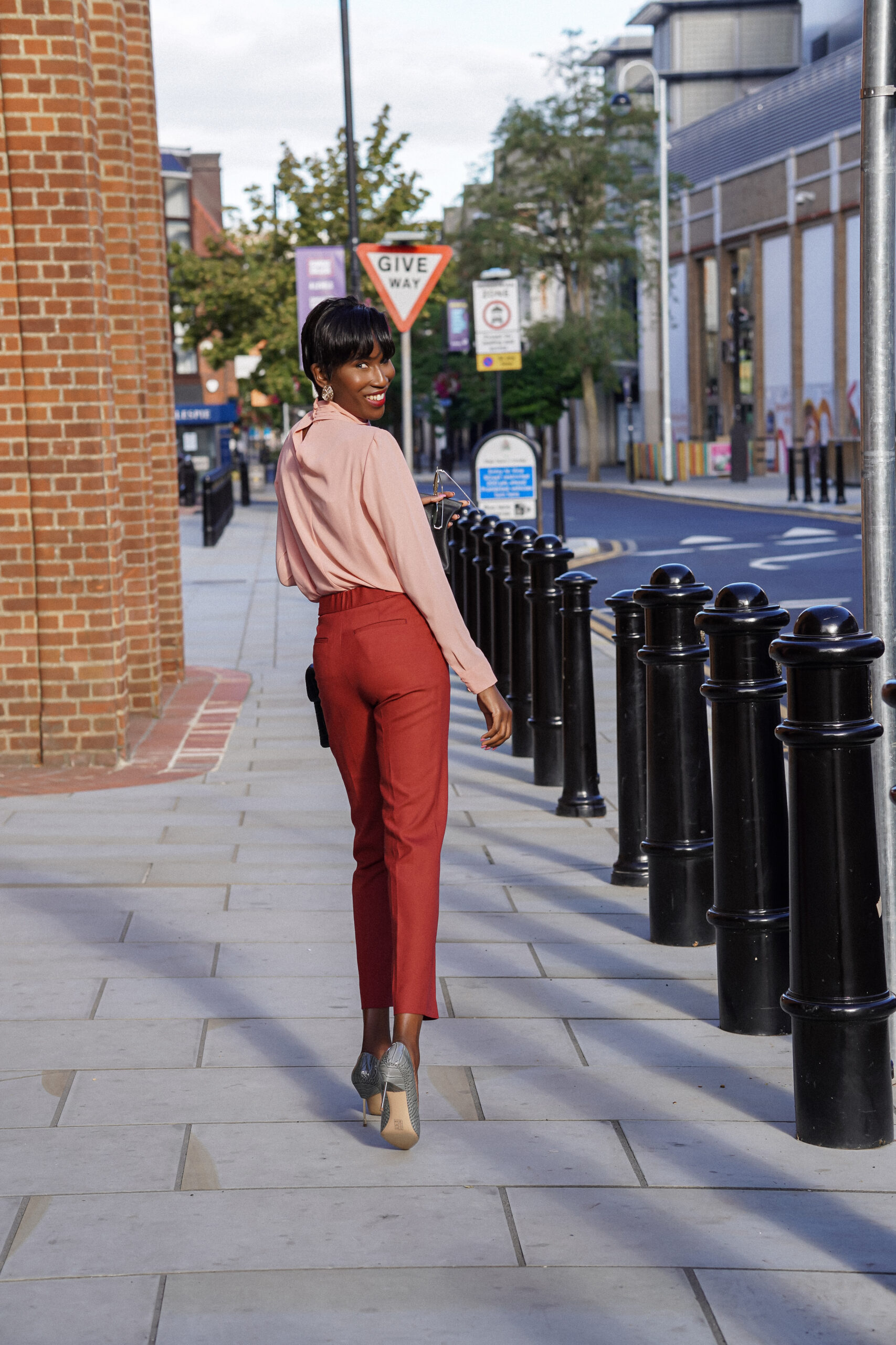 Hip-Hop style. Woman. An interesting ultra-modern fashionable style of an  oversize peach color shirt. Free form. Palazzo trousers
