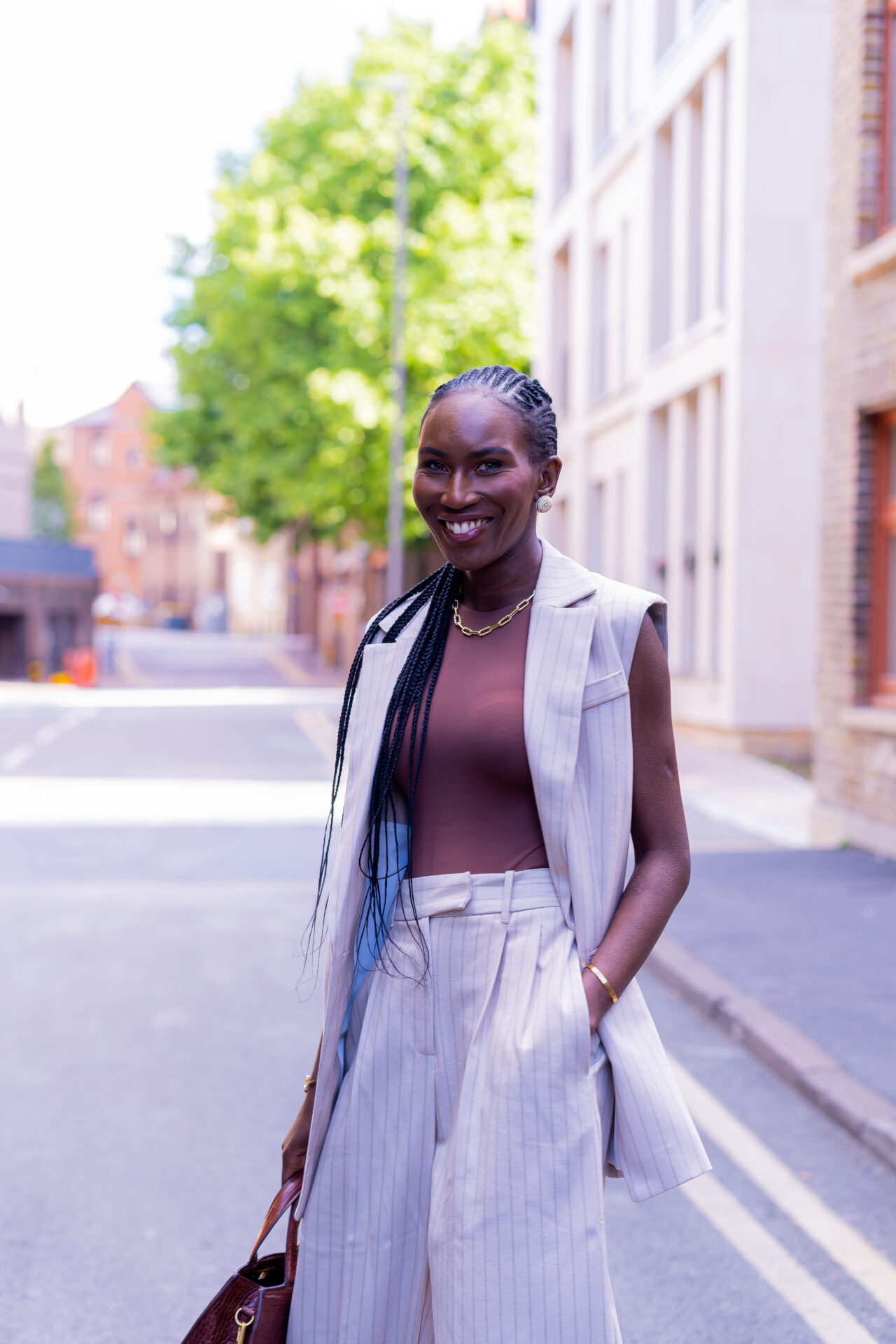 How to dress for the office during a heatwave with a chic linen sleeveless blazer and tailored trousers outfit.